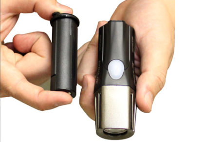 Cygolite one piece USB rechargeable headlight held in hand with its removable battery