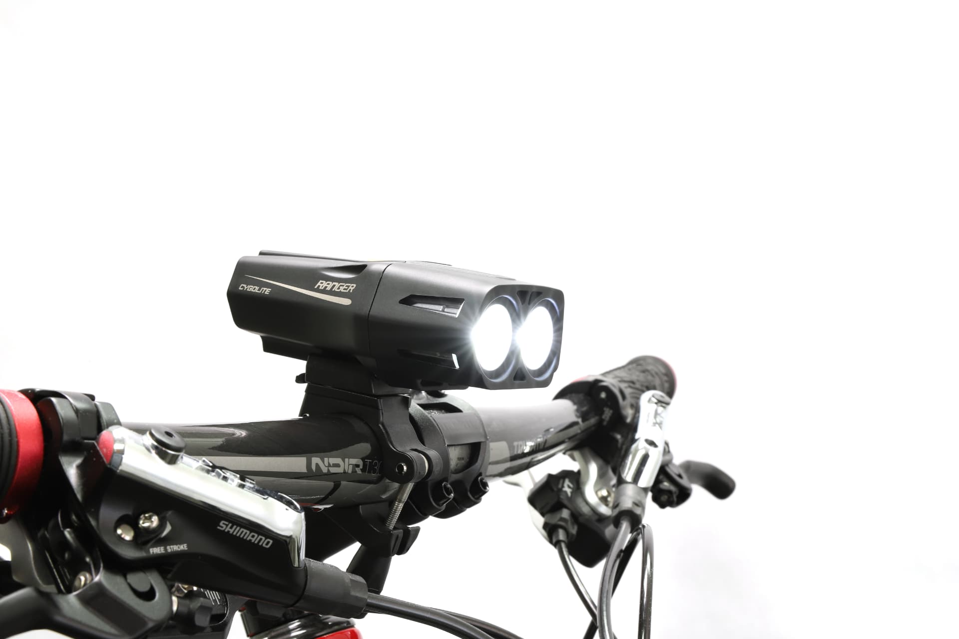 Cygolite Ranger Endurance dual-LED headlight lit on mountain bike handlebars