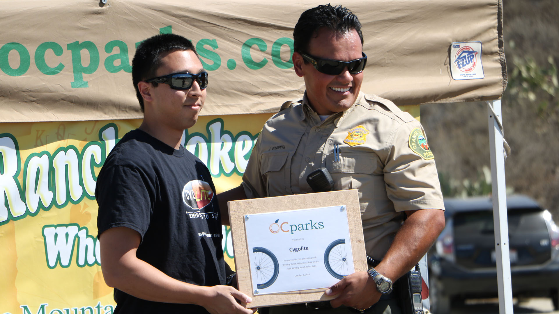 Cygolite team member receiving a community partnership award at a local park ride